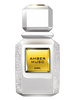 A bottle of AJMAL Amber Musc perfume with a faceted white glass body, textured white sides, and a prominent gold label in the center.